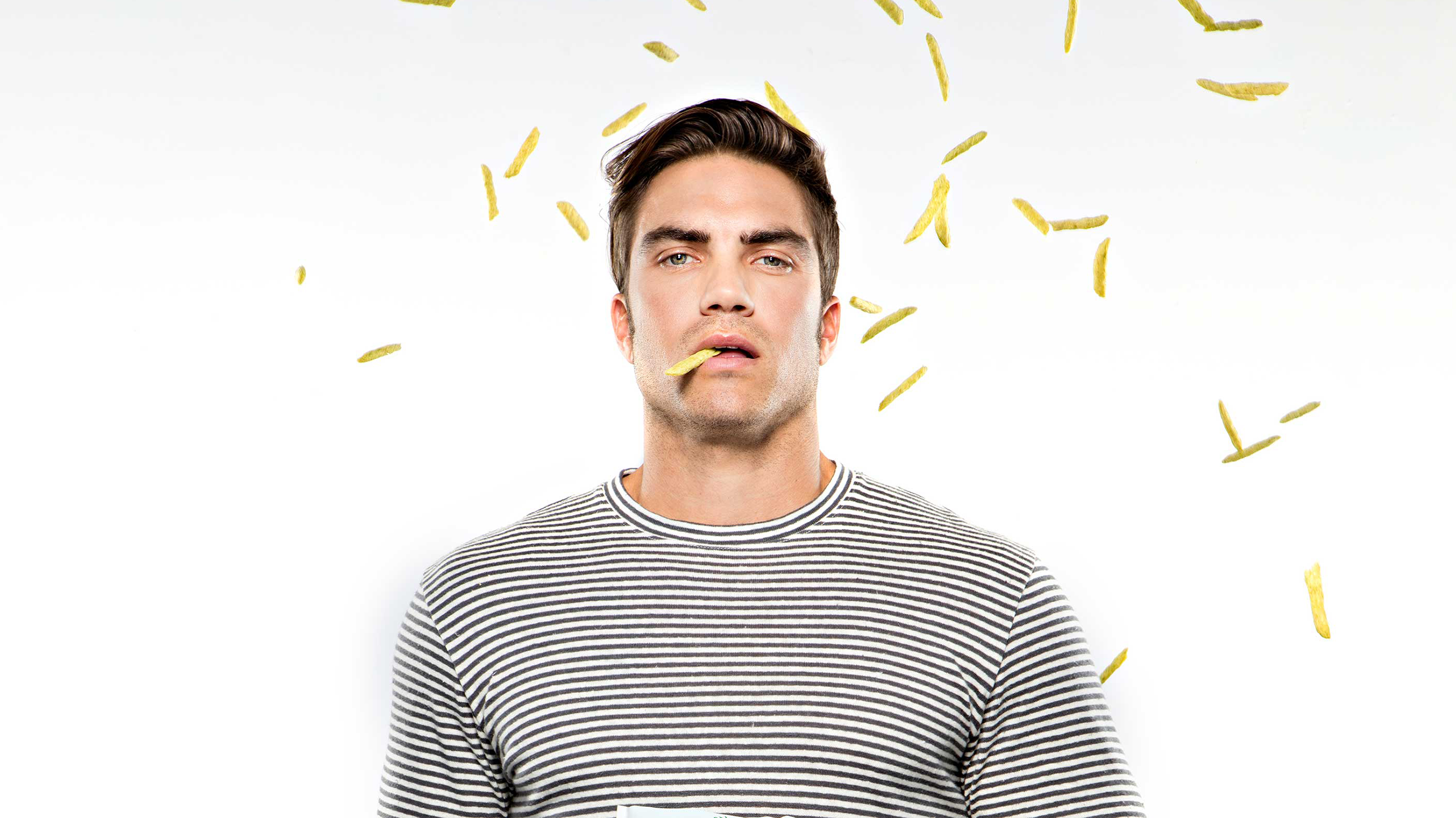 Man with harvest snaps hanging out of mouth